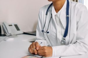 https://www.pexels.com/photo/a-woman-in-white-coat-sitting-at-the-table-7578800/
